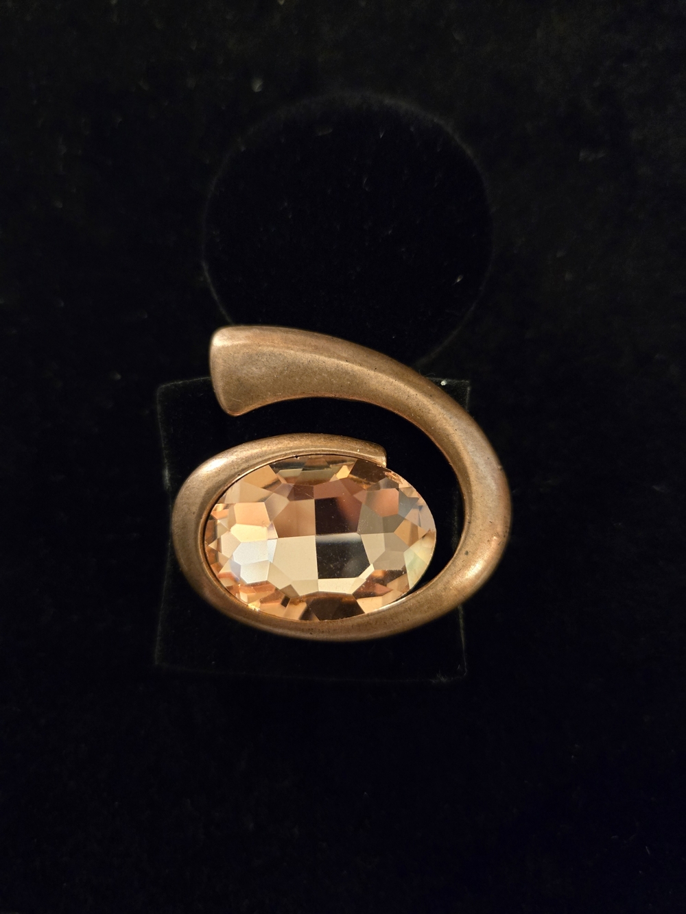 Elegant Copper-Tone Swirl Ring with Peach Crystal